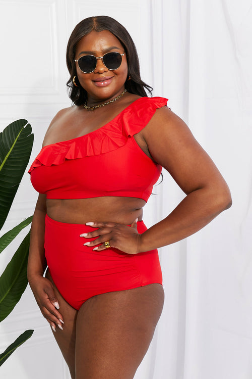 Discover elegance with the Marina West Swim Seaside Romance Ruffle One-Shoulder Bikini in Red. Perfect for the beach or pool, this two-piece set features a stylish asymmetrical top and high-waisted ruched bottoms. Enjoy comfort with removable pads and a blend of 83% polyester and 17% spandex. Ideal for confident swims and lounging in style.