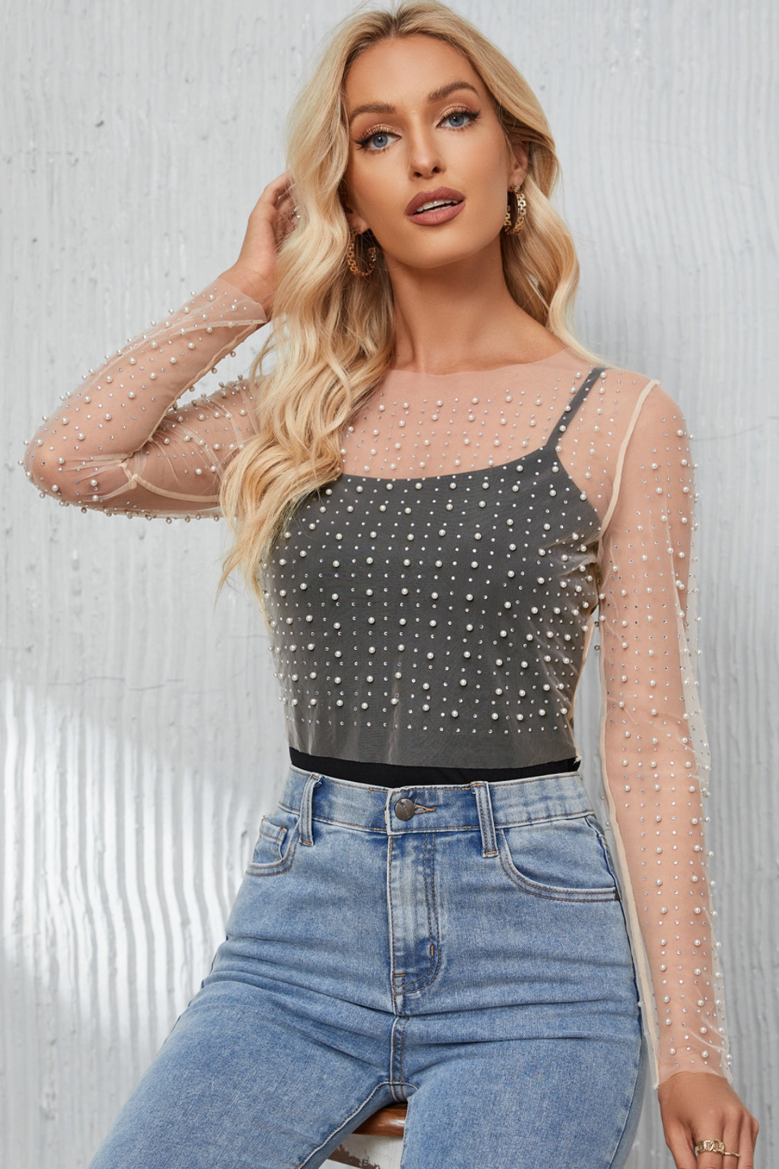 Elegant Pearl Long Sleeve Mesh Cropped Top with rhinestone detailing. Made from a blend of polyester and elastane. Semi-sheer and slightly stretchy for a sophisticated look. Available in sizes S to XL.