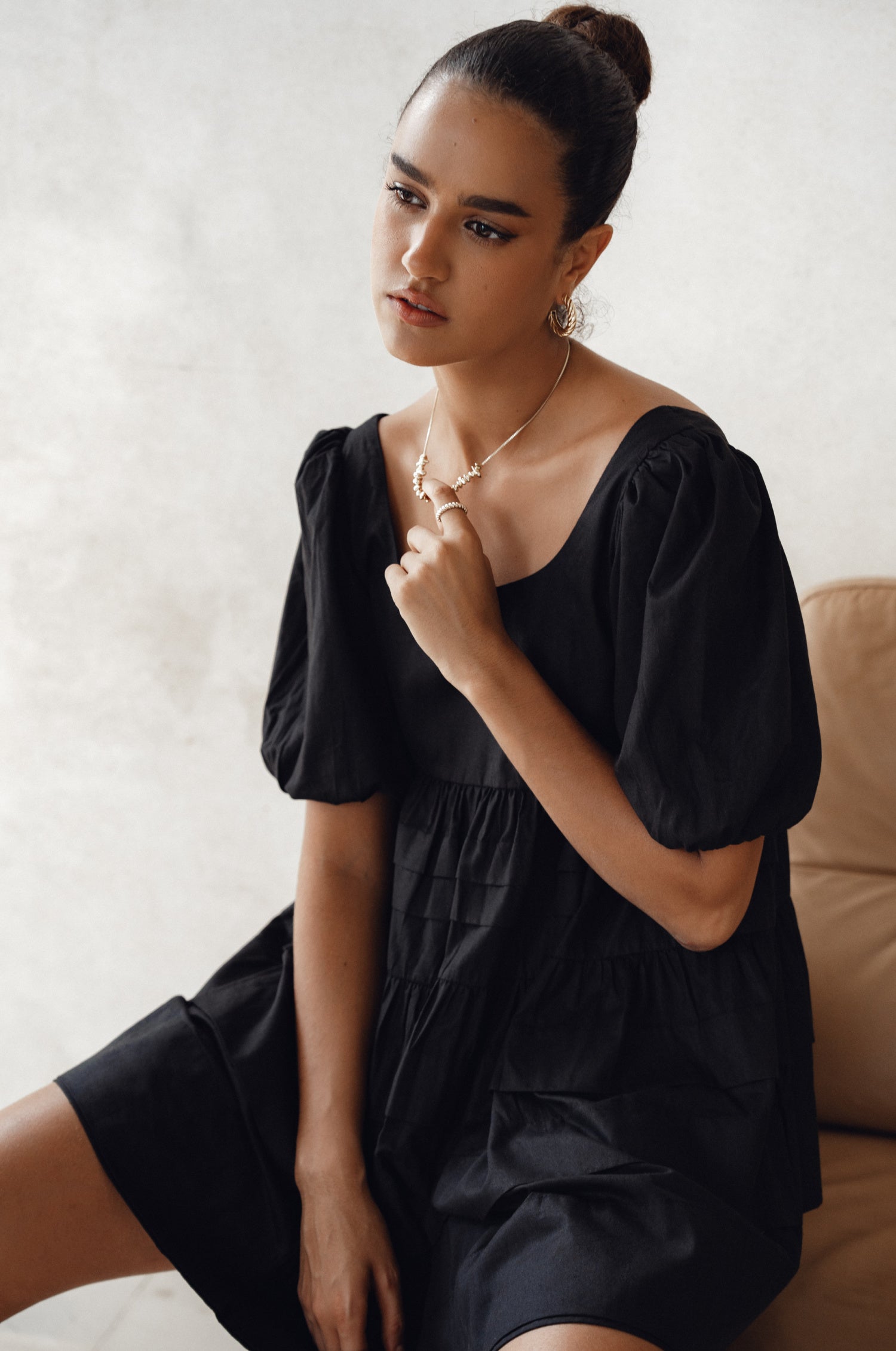 Achieve effortless femininity with the Andrea Babydoll Cotton Mini Dress. Handmade from breathable poplin cotton, this dress features elasticated sleeves, chic folds on the hem, and a flattering round neckline. 