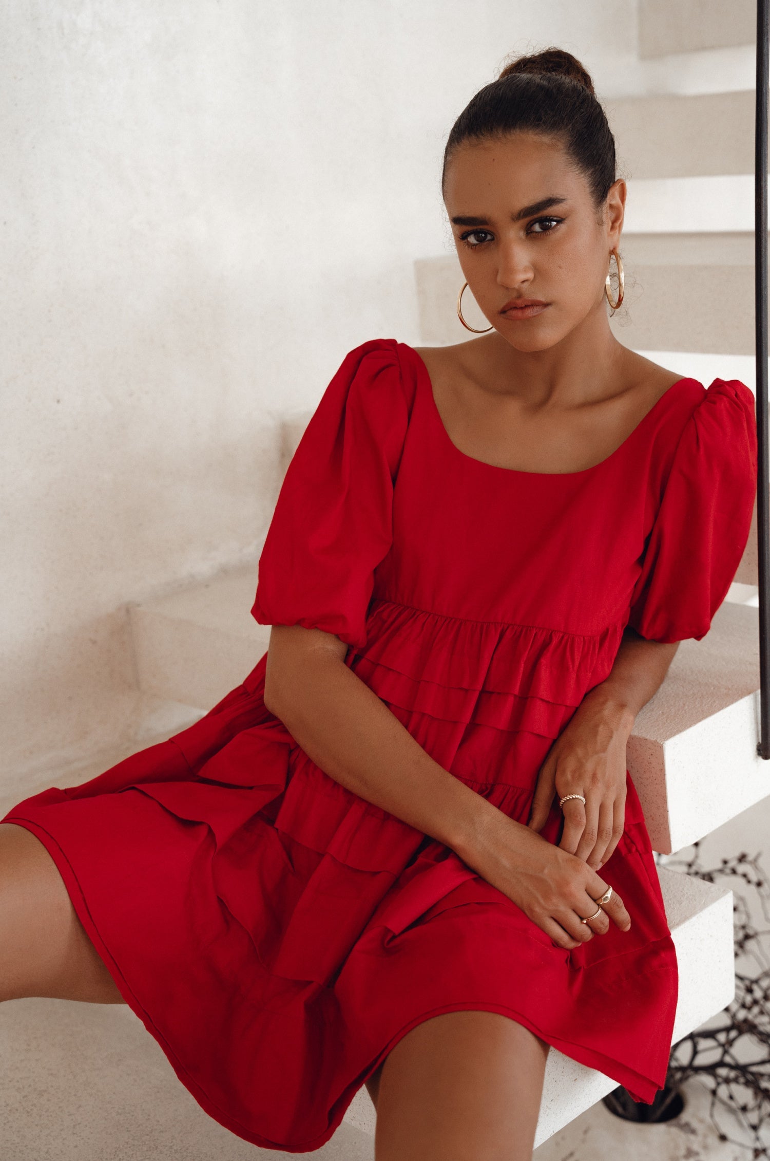 Achieve effortless femininity with the Andrea Babydoll Cotton Mini Dress. Handmade from breathable poplin cotton, this dress features elasticated sleeves, chic folds on the hem, and a flattering round neckline. 