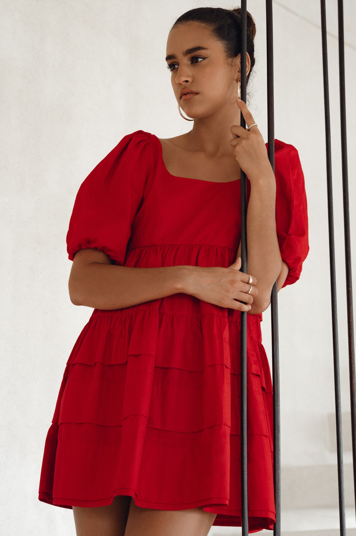 Achieve effortless femininity with the Andrea Babydoll Cotton Mini Dress. Handmade from breathable poplin cotton, this dress features elasticated sleeves, chic folds on the hem, and a flattering round neckline. 