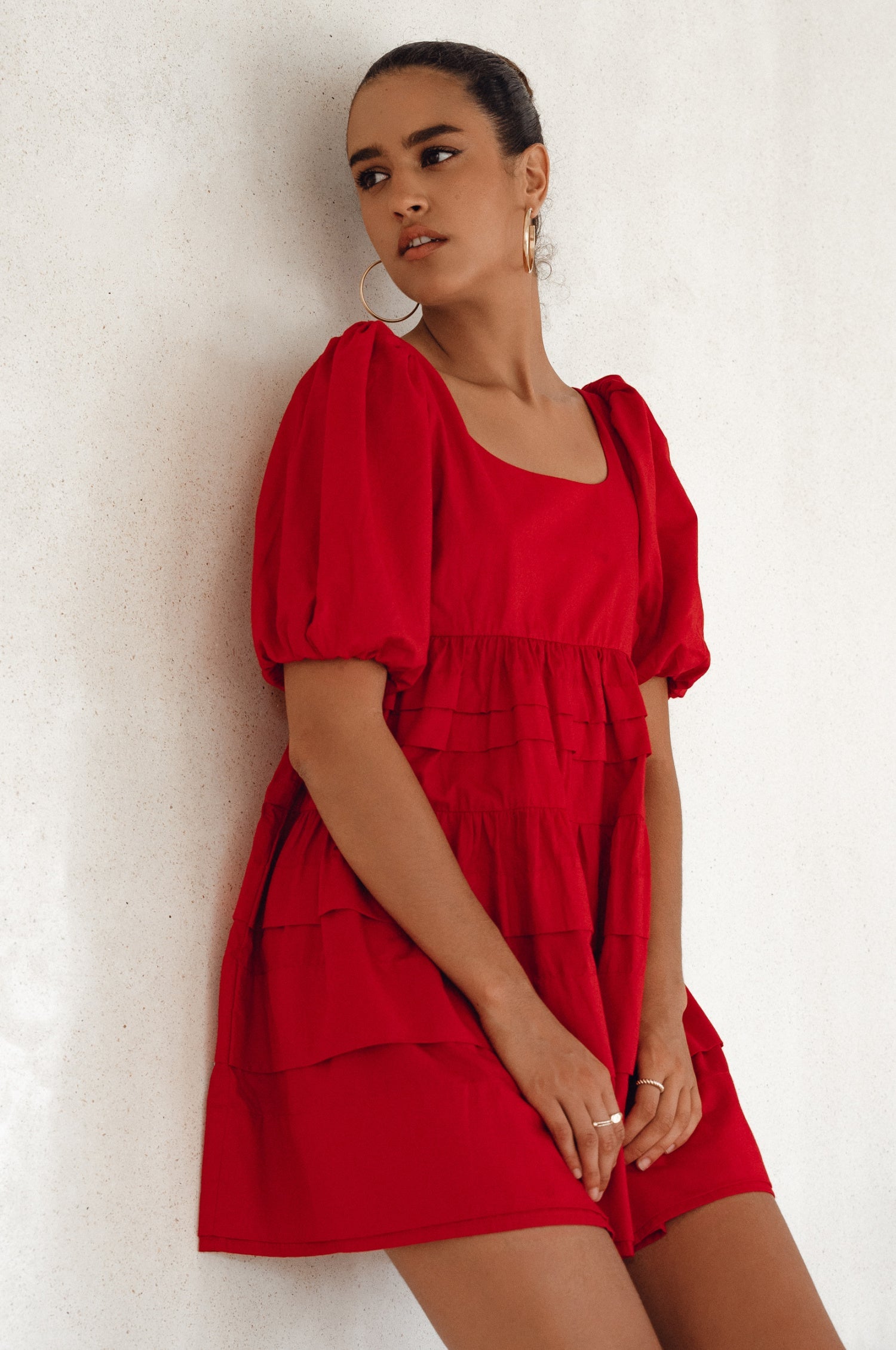 Achieve effortless femininity with the Andrea Babydoll Cotton Mini Dress. Handmade from breathable poplin cotton, this dress features elasticated sleeves, chic folds on the hem, and a flattering round neckline. 