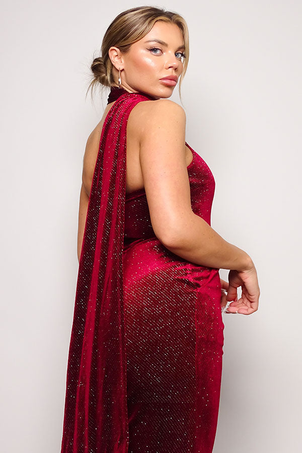 Embrace glamour in our Burgundy Glitter Velvet Jumpsuit with a chic scarf top. Perfect for a night out, this sleeveless one-shoulder outfit ensures style and comfort. Available now in the United States.