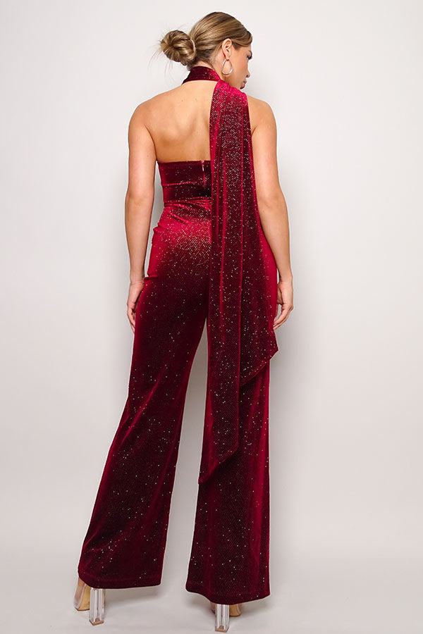 Embrace glamour in our Burgundy Glitter Velvet Jumpsuit with a chic scarf top. Perfect for a night out, this sleeveless one-shoulder outfit ensures style and comfort. Available now in the United States.