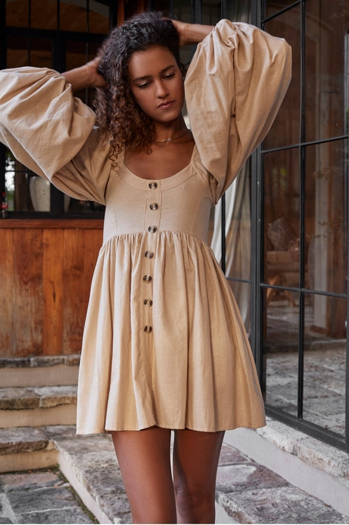 Experience effortless charm with the Chloie Empire Waist Linen Mini Dress. Designed with gorgeous long puff sleeves, a smocked square shape back, and elasticated sleeves, this easy-to-wear dress is perfect for any occasion. 