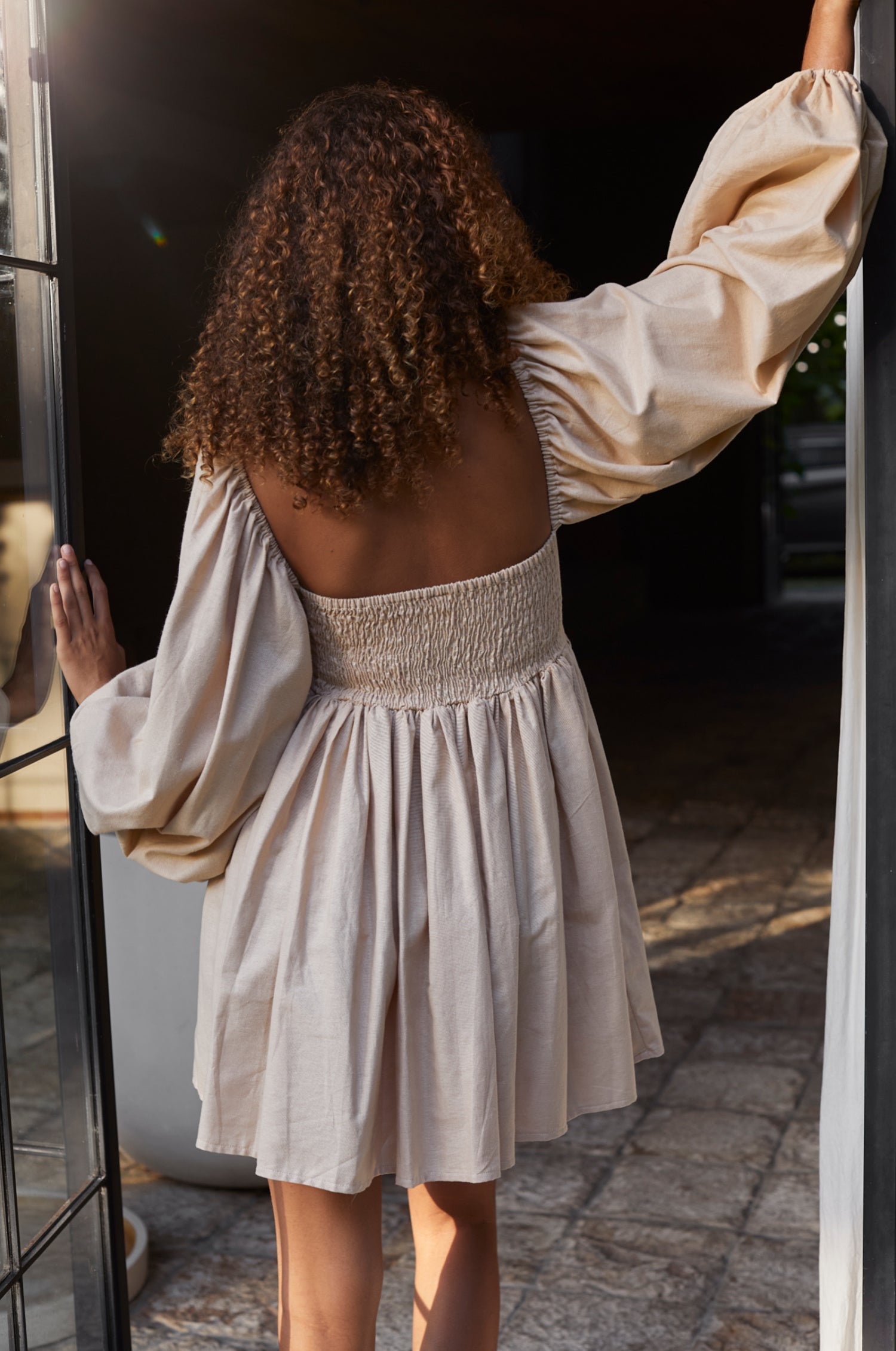 Experience effortless charm with the Chloie Empire Waist Linen Mini Dress. Designed with gorgeous long puff sleeves, a smocked square shape back, and elasticated sleeves, this easy-to-wear dress is perfect for any occasion. 