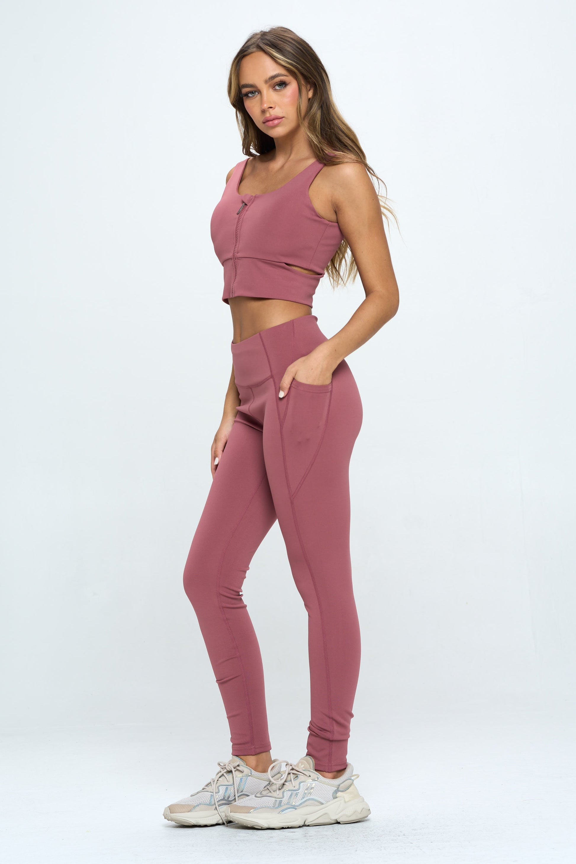 Trendy 2 Piece Zip Up Crop Sports Tank Top Set with high-waisted biker shorts. Perfect for running and workouts. Made of high-stretch nylon (78% Nylon, 22% Spandex). Stylish and comfortable activewear set for women. Machine washable and suitable for professional dry clean.