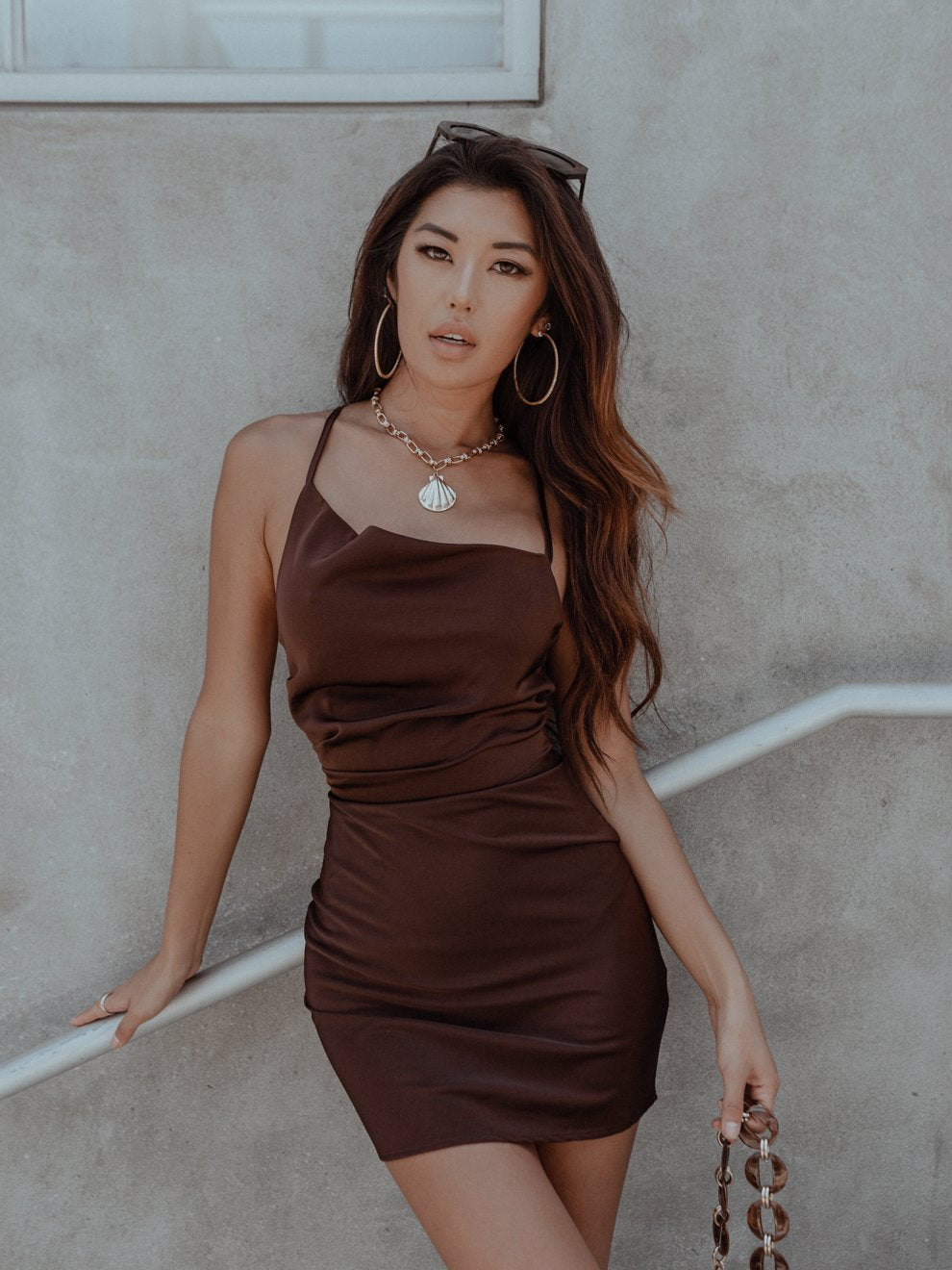 RSVP Yes to style with our chic asymmetrical party dress. This slim-fit mini dress features a trendy asymmetrical neckline and adjustable criss-cross straps at the back.