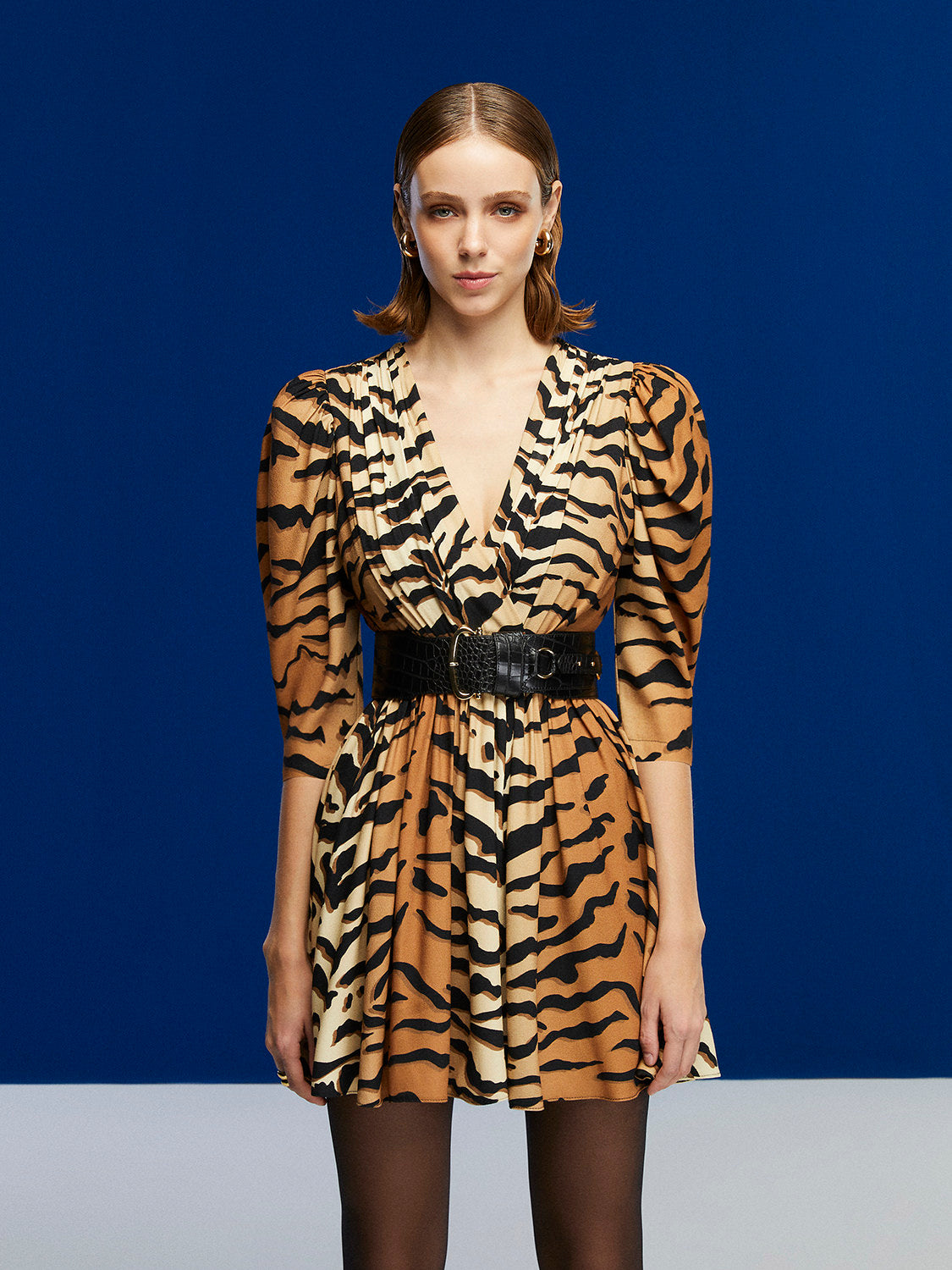 Unleash the wild with our Tiger Print Mini Dress! A V-neck, double-breasted beauty featuring a flounced hem. Mega charm meets leopard touches and energizing green accents. Made from 51% Viscose, 49% Rayon. Handle with care for this delicate dress. Roar into style with the spirit of the tiger.