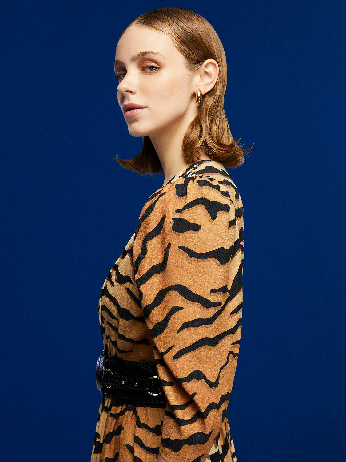 Unleash the wild with our Tiger Print Mini Dress! A V-neck, double-breasted beauty featuring a flounced hem. Mega charm meets leopard touches and energizing green accents. Made from 51% Viscose, 49% Rayon. Handle with care for this delicate dress. Roar into style with the spirit of the tiger.