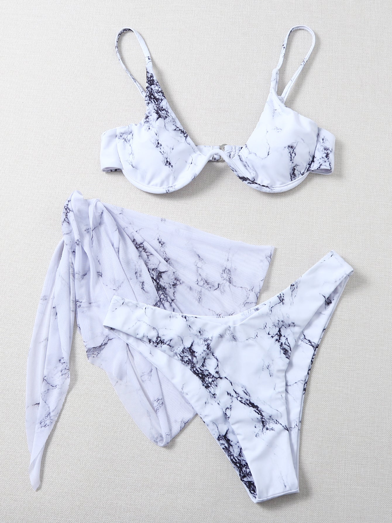 Elevate your beach style with the Marble Print Bikini featuring a flattering underwire design. This two-piece swimsuit offers comfort and style. Check our size chart for the perfect fit.