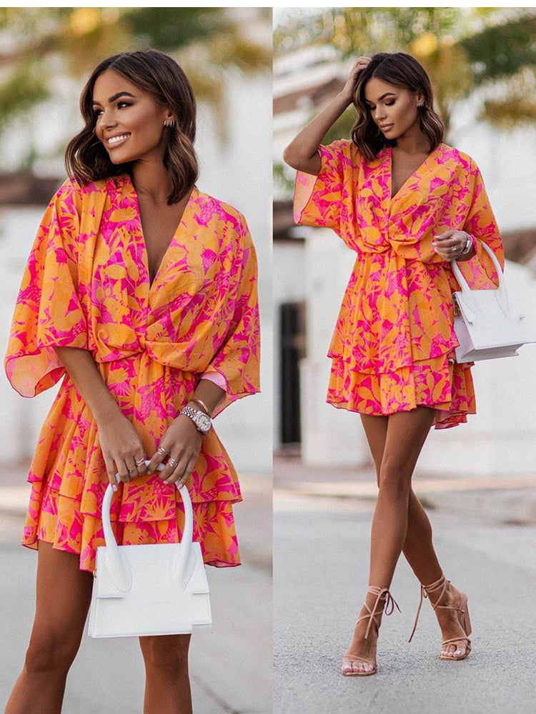 Chic V-neck Mini Dress for beach parties. Batwing sleeves, vibrant print, and A-line silhouette. Elevate your style effortlessly. Shop now!