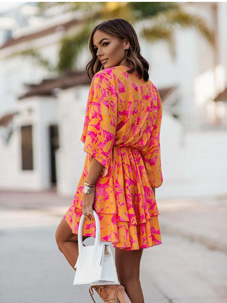 Chic V-neck Mini Dress for beach parties. Batwing sleeves, vibrant print, and A-line silhouette. Elevate your style effortlessly. Shop now!