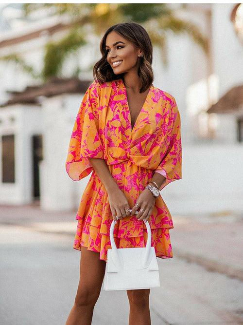 Chic V-neck Mini Dress for beach parties. Batwing sleeves, vibrant print, and A-line silhouette. Elevate your style effortlessly. Shop now!