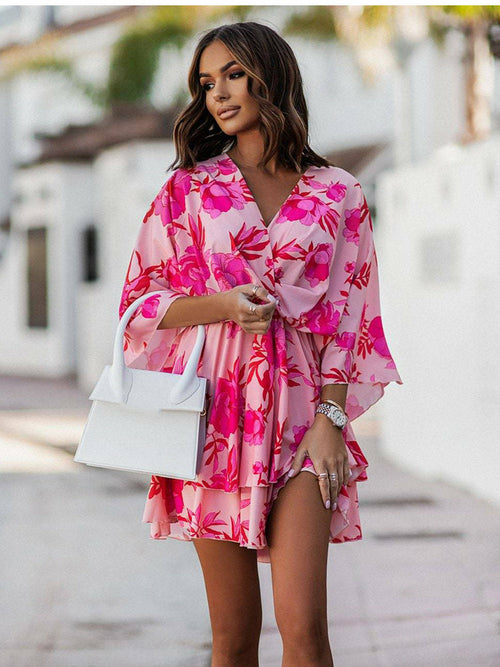 Chic V-neck Mini Dress for beach parties. Batwing sleeves, vibrant print, and A-line silhouette. Elevate your style effortlessly. Shop now!