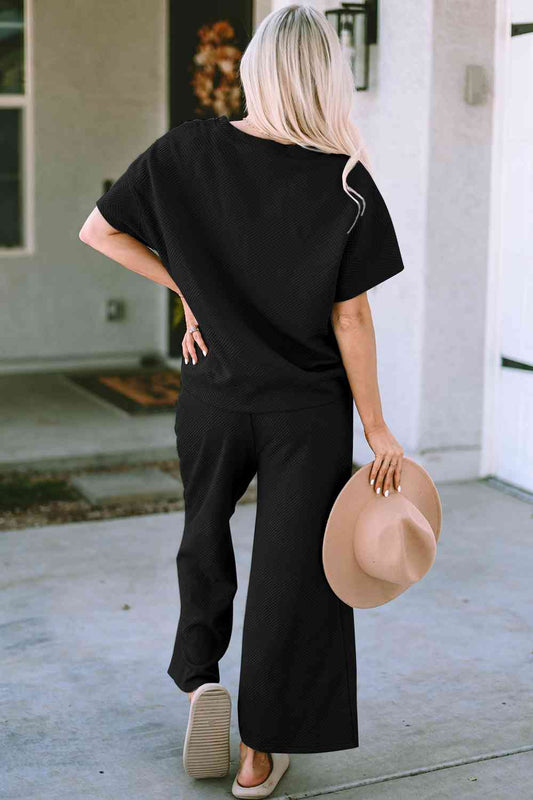 Stay comfortable and stylish in our Short Sleeve Top and Pants Set. Two-piece lounge wear made from a blend of polyester and spandex. Features a drawstring for a customizable fit. Available in sizes S to 2XL.