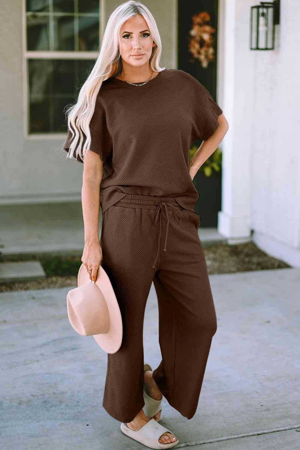 Stay comfortable and stylish in our Short Sleeve Top and Pants Set. Two-piece lounge wear made from a blend of polyester and spandex. Features a drawstring for a customizable fit. Available in sizes S to 2XL.