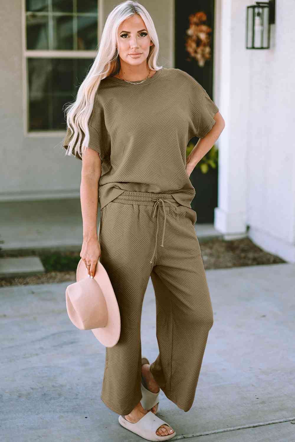 Stay comfortable and stylish in our Short Sleeve Top and Pants Set. Two-piece lounge wear made from a blend of polyester and spandex. Features a drawstring for a customizable fit. Available in sizes S to 2XL.