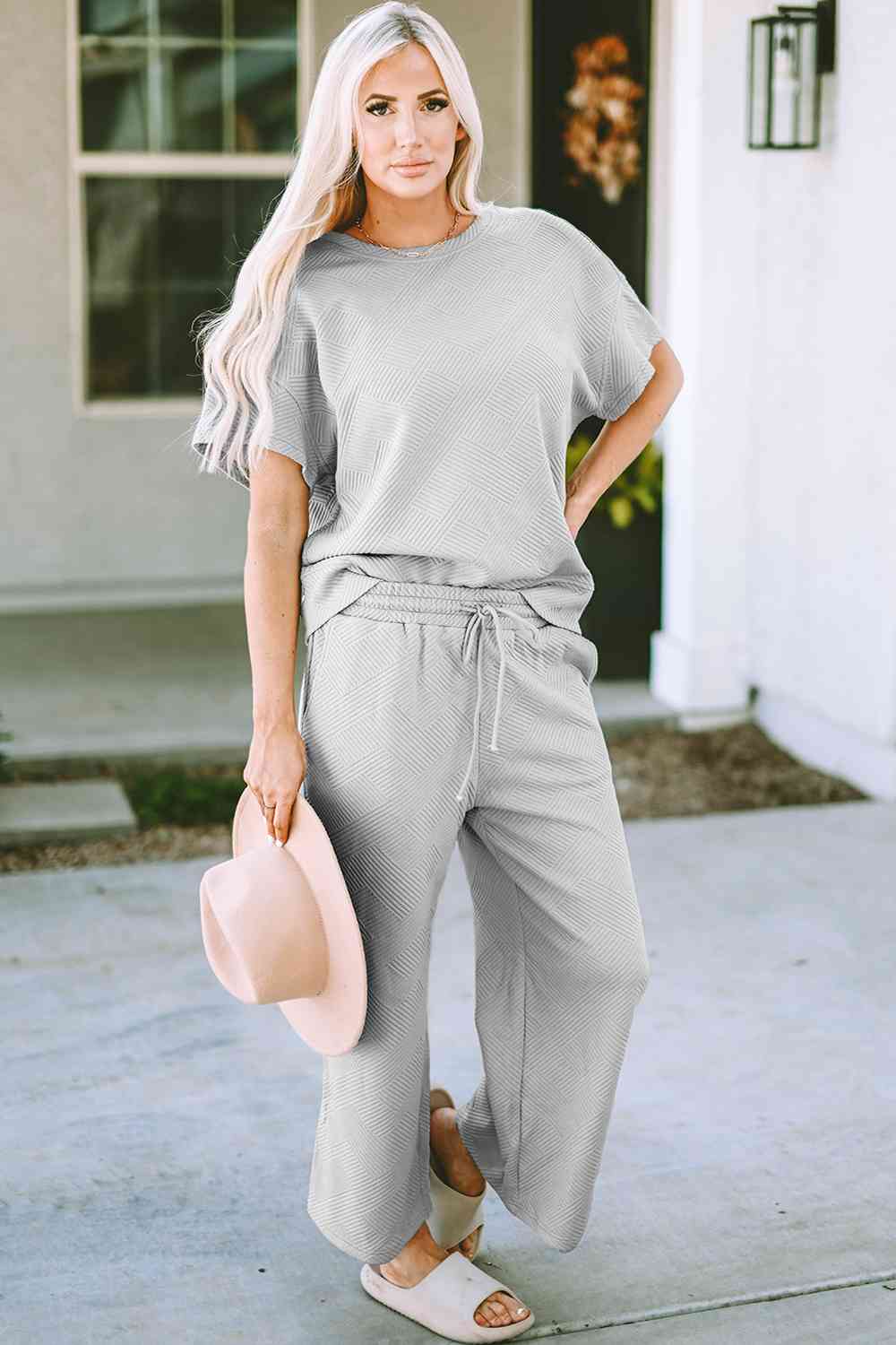 Stay comfortable and stylish in our Short Sleeve Top and Pants Set. Two-piece lounge wear made from a blend of polyester and spandex. Features a drawstring for a customizable fit. Available in sizes S to 2XL.