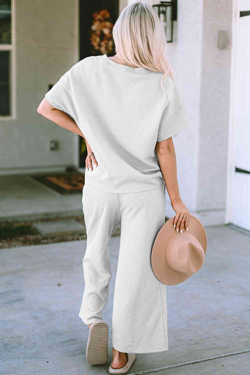 Stay comfortable and stylish in our Short Sleeve Top and Pants Set. Two-piece lounge wear made from a blend of polyester and spandex. Features a drawstring for a customizable fit. Available in sizes S to 2XL.