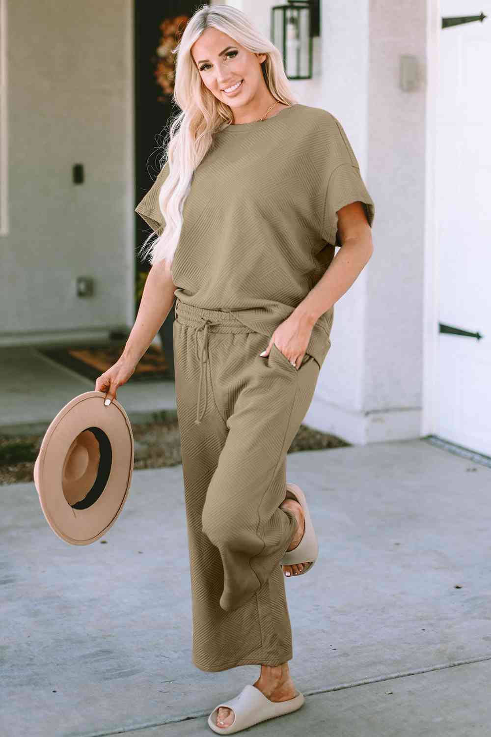 Stay comfortable and stylish in our Short Sleeve Top and Pants Set. Two-piece lounge wear made from a blend of polyester and spandex. Features a drawstring for a customizable fit. Available in sizes S to 2XL.