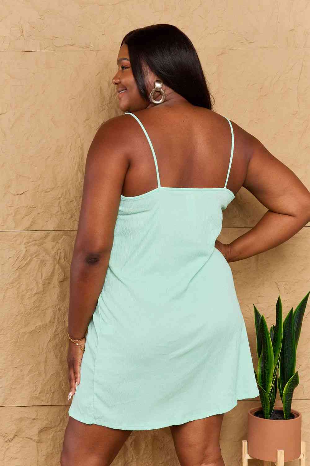 Ninexis Saw You First Mini Dress - Chic and confident style in a solid slim-fitting silhouette. Adjustable spaghetti straps for a delicate touch. Crafted from a soft and stretchy blend for all-day comfort. Made in the USA, perfect for any occasion.