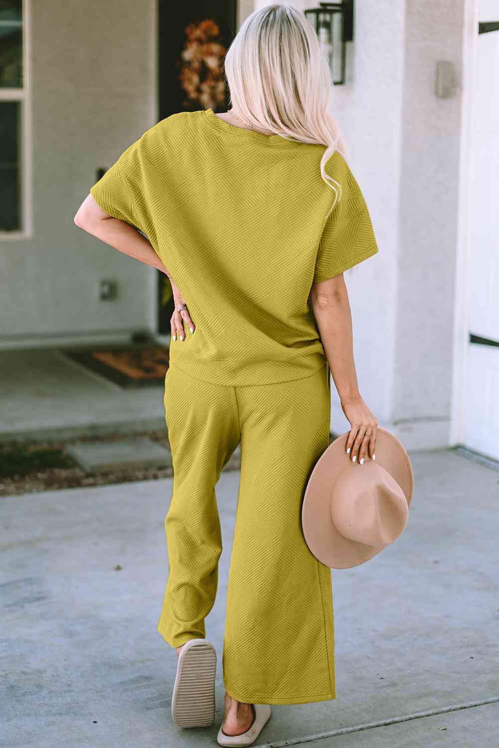 Stay comfortable and stylish in our Short Sleeve Top and Pants Set. Two-piece lounge wear made from a blend of polyester and spandex. Features a drawstring for a customizable fit. Available in sizes S to 2XL.