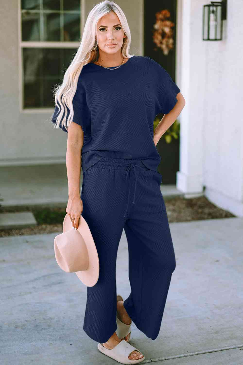 Stay comfortable and stylish in our Short Sleeve Top and Pants Set. Two-piece lounge wear made from a blend of polyester and spandex. Features a drawstring for a customizable fit. Available in sizes S to 2XL.